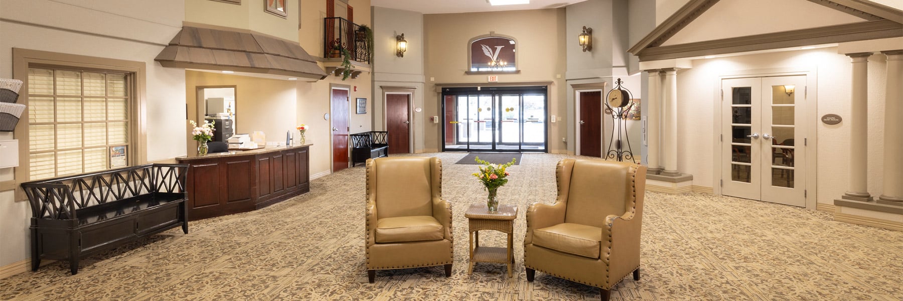 Front entrance with seating and chandelier at the Villages of Jackson Creek